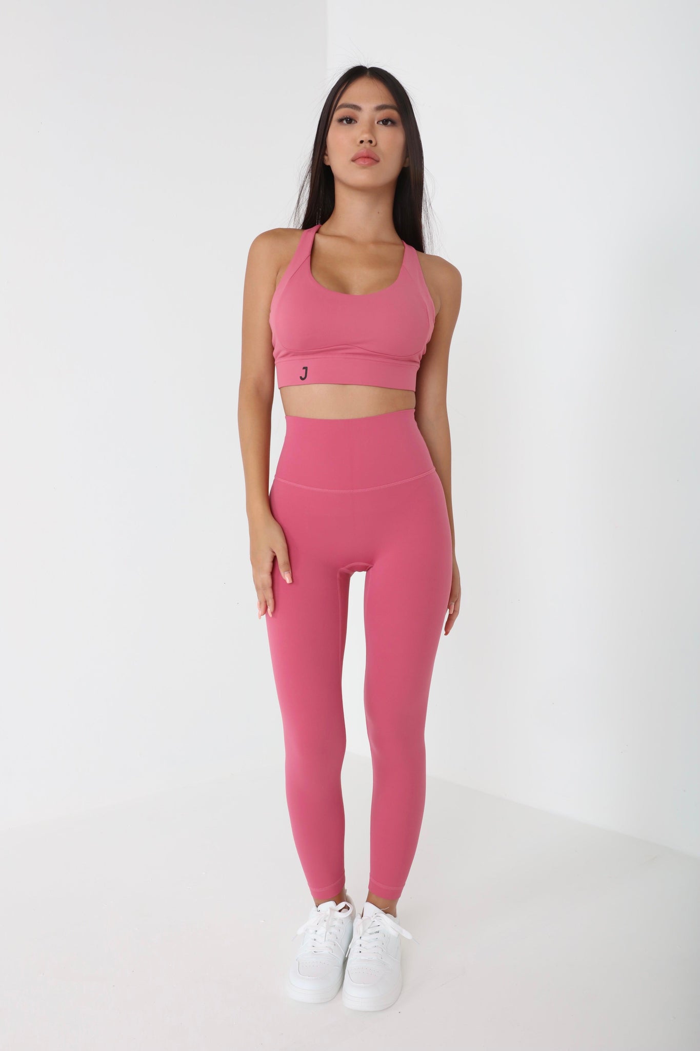 JUV fresh legging in pink color with matching top, full body front view.